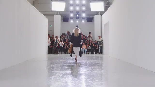 Catwalk van de Bottega Veneta-show in Milaan met rijen gasten aan het eind van de zaal